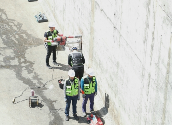 관계자들이 콘크리트 압축강도 확인과 구조물의 잔존 수명을 예측하는 시연을 진행하고 있다.